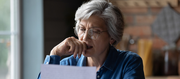 Image of a senior citizen holding a document